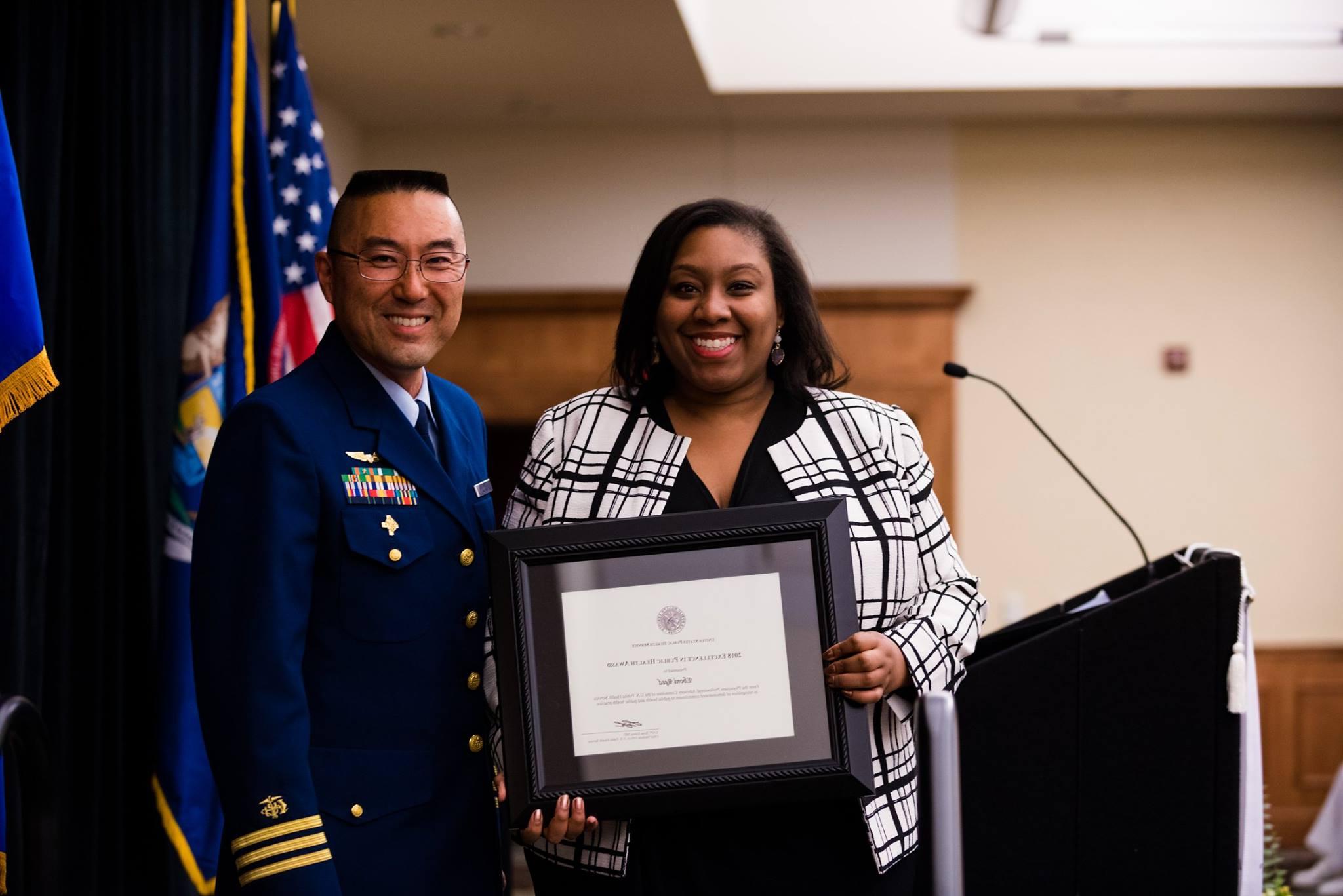 Student accepted framed award at Honors Convocation.